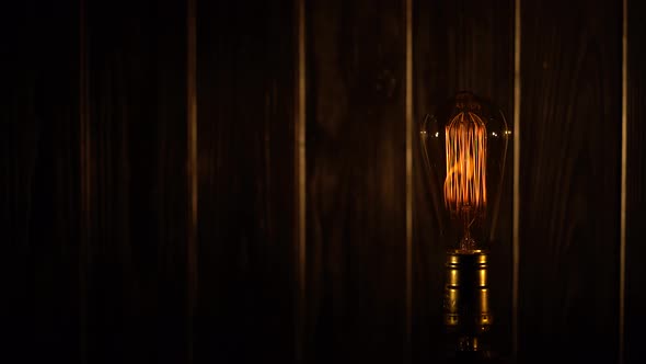 Retro Light Bulb Lighting on a Wooden Background