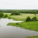Flying Over the Lake, Green Meadows and Forest on Cloudy Summer Day - VideoHive Item for Sale