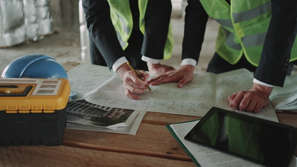 Two Experts Engineer Making Plan of Construction Site