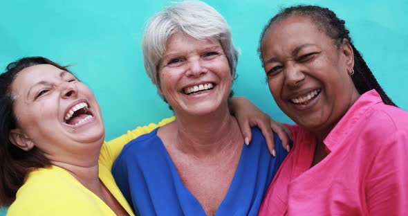 Joyful elderly women having fun in the city - Senior multiracial friendship concept