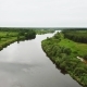 Flying Over the River Flowing Along the Fields and Forests - VideoHive Item for Sale