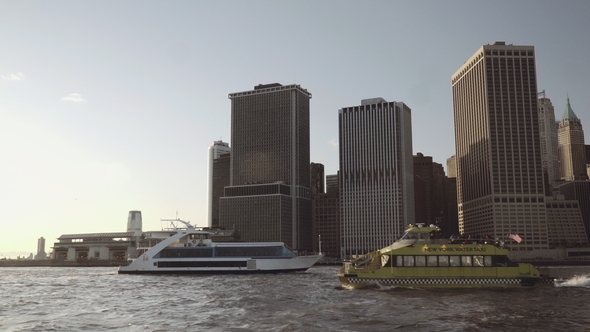 Taxi Boat Passing By Yacht with Financial Skyscrapers in Downtown New York in Lower Manhattan Filmed