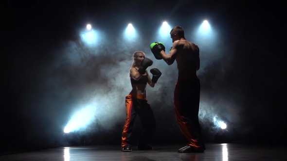 Men with a Girl Preparing for a Kickboxing Competition