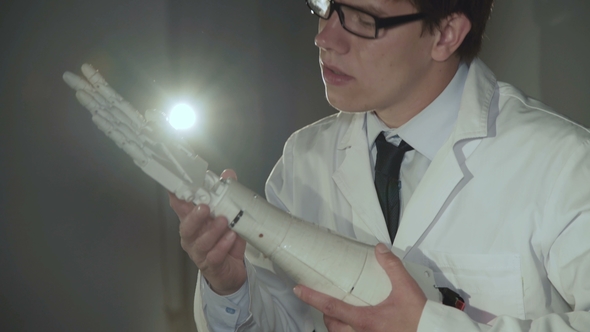 The Scientist Testing the Robotic Hand in the Lab