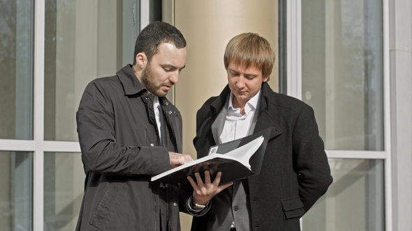 Two Businesspeople Looking at Papers
