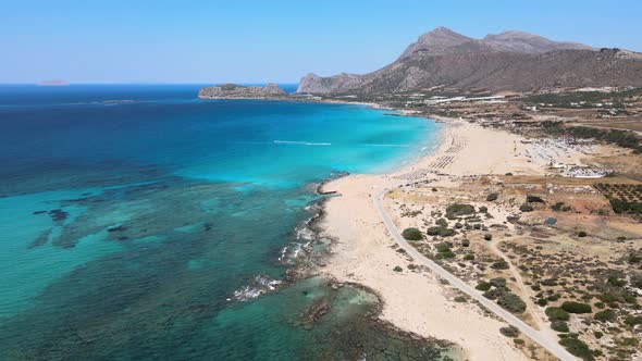 Smooth drone aerial Greece beach pan down with mountains