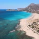 Smooth drone aerial Greece beach pan down with mountains - VideoHive Item for Sale