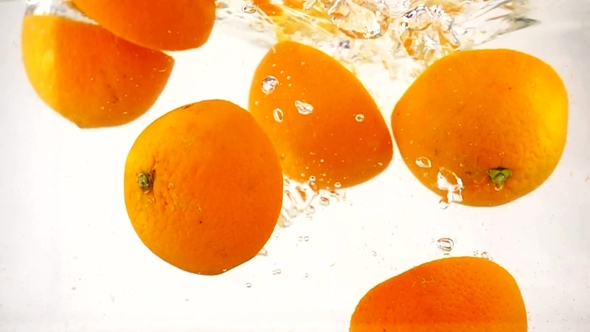 Juicy Orange Halves Are Immersed in Water