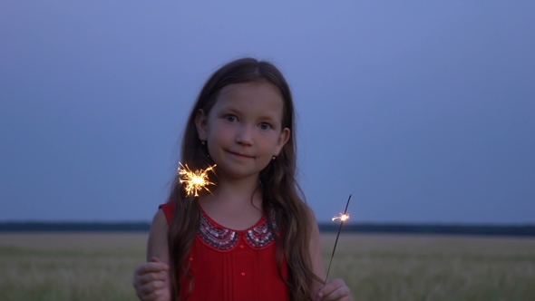 Portrait of a Girl with Sparklers in Their Hands at Evening.