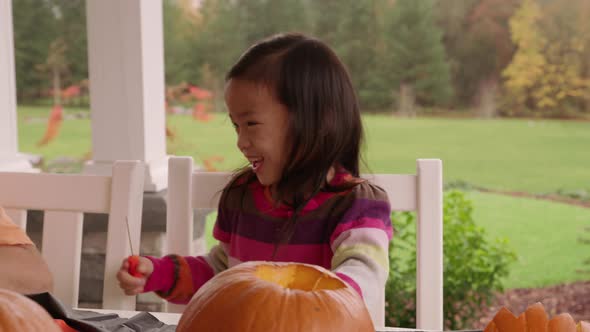 Kids carving pumpkins for Halloween