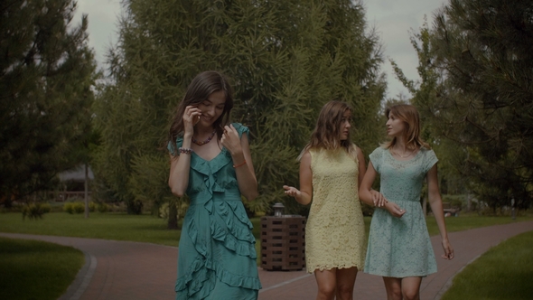 Cheerful Woman Phubbing Her Friends in Park