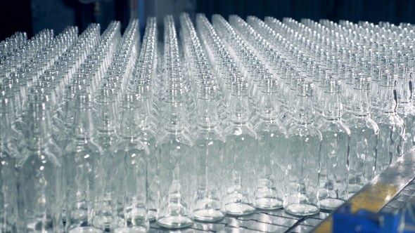 Lots of Clear Bottles on a Large Conveyor