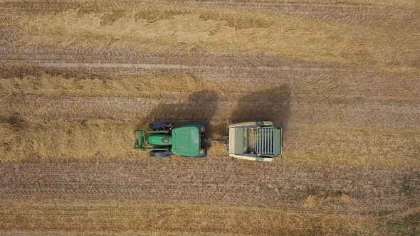 Aerial of Working Hay Baler Tractor