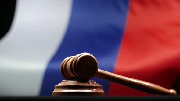 Judge's Wooden Gavel On Block Against Russian Flag Waving In Russian Federation Court Room alt