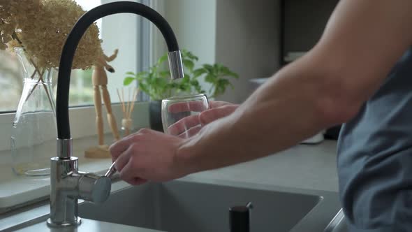 Man Pouring Water in Glass