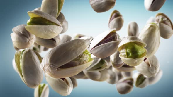 Flying of Pistachios in Cyan Background