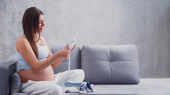 Young pregnant woman is resting at home and expecting a baby.