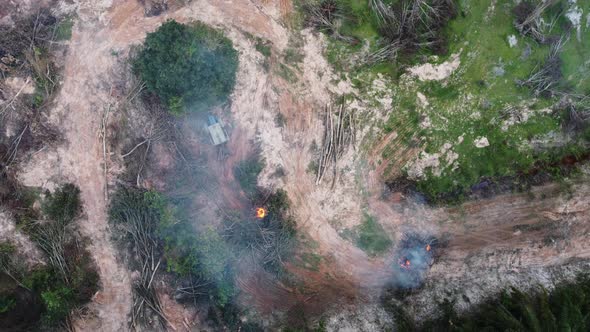 Aerial view tractor involve in open burning of oil palm tree