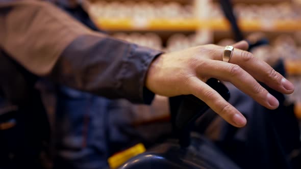 Closeup Forklift Male Operator Hands Switch Levers to Control the Loading Process on Warehouse