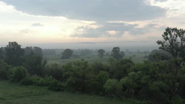 Tranquil flight above the misty spring landscape 4K drone footage