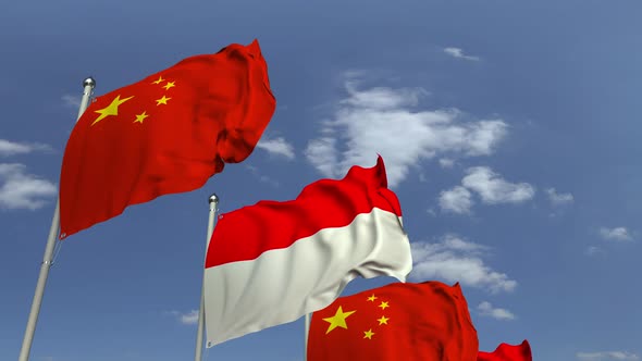 Flags of Indonesia and China Against Blue Sky