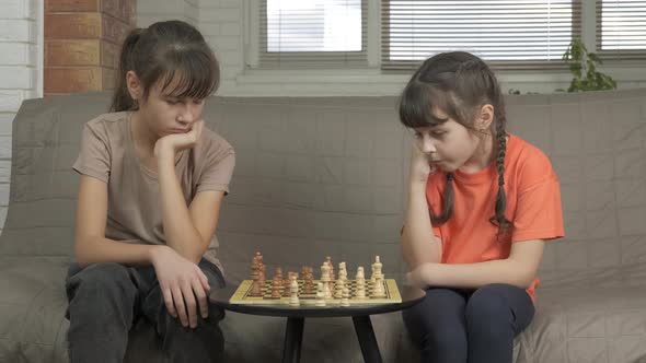 Sisters Play Smart Chess in Room
