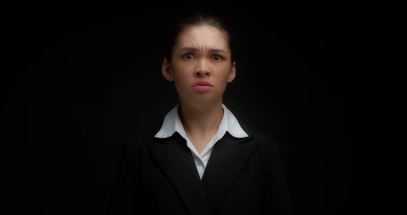 Woman Looks with a Displeased Expression and Shows a Stop Gesture with Her Hand