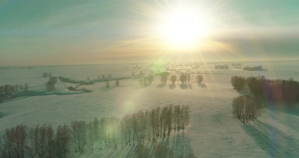 Aerial View of Cold Winter Landscape Arctic Field Trees Covered with Frost Snow Ice River and Sun