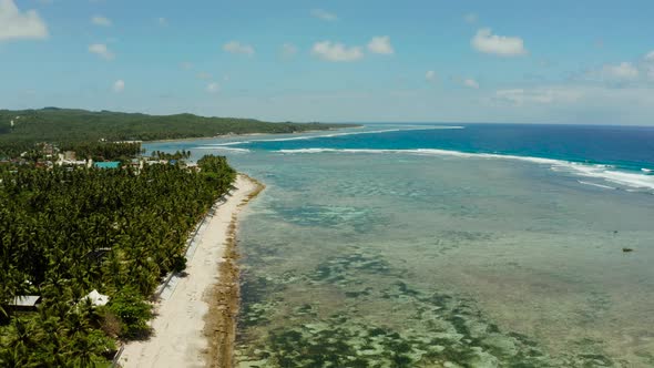 The Coast of Siargao Island, Blue Ocean and Waves.