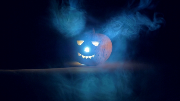 Dark Room with Clouds of Mist and a Glowing Jack-o-lantern