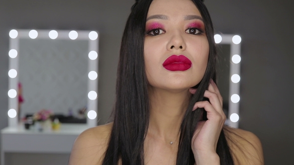Asian Young Woman with Bright Lipstick Posing at Camera