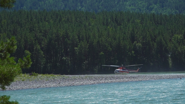 The Mi-8 Helicopter Is on the Bank of a Mountain River