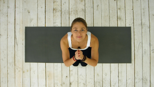 Sporty Woman with Joined Hands in Fitness Studio