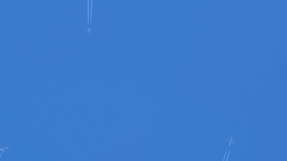 Air Traffic View of Airplane Jet Layer White Trace Vapour on Blue Clean Sky