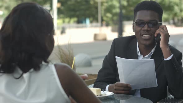 Afro-american Business Couple Having a Metting in Cafe