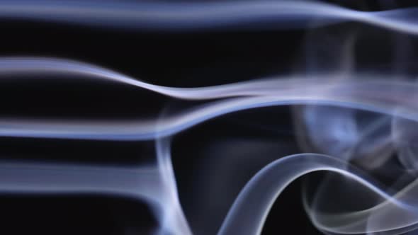 Beautifully Moving Smoke Dances on a Black Background
