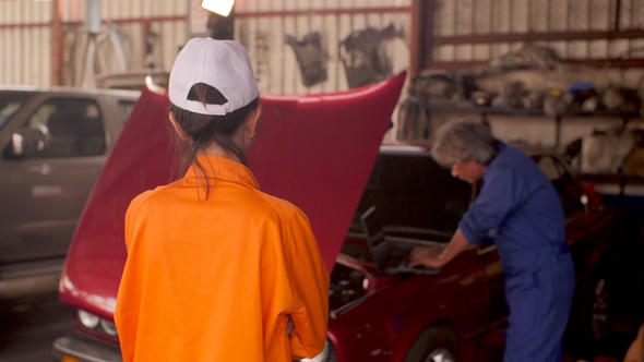 Portrait of a Young Beautiful Car Mechanic in a Car Workshop