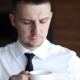 Young Man in a White Shirt Drinking Coffee, - VideoHive Item for Sale
