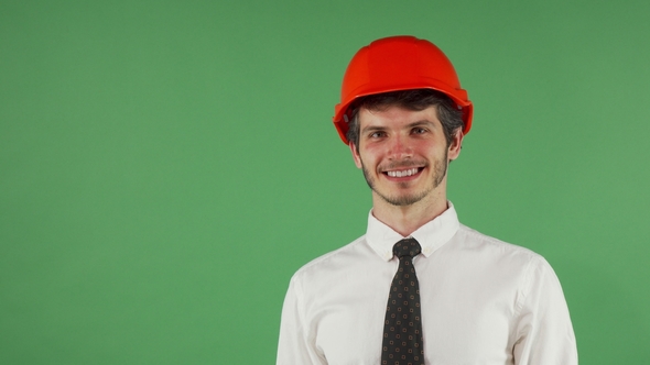 Cheerful Handsome Male Engineer Wearing Hardhat Winking To the Camera