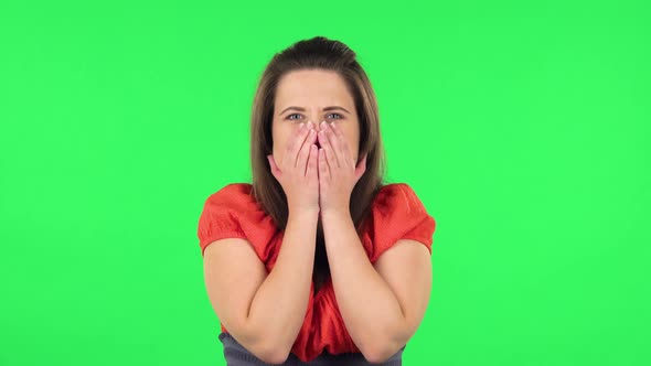 Portrait of Girl Carefully Examines Something Then Fearfully Covers Her Face with Her Hands. Green