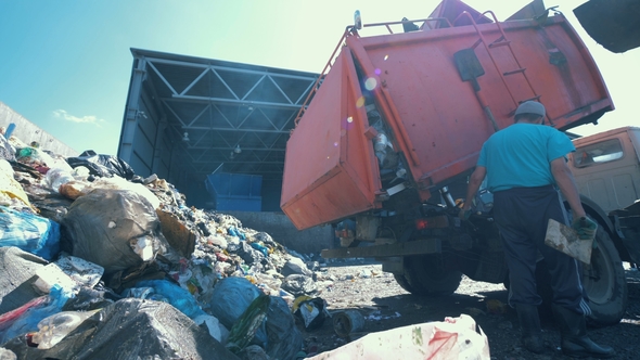 Litter Is Getting Discarded From a Truck in a Scrapyard