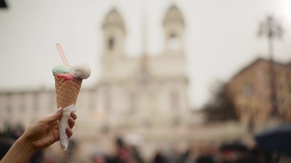 Woman Hand Holding an Ice Cream, Blurred Piazza Di Spagna in Rome Italy