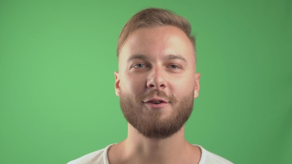 Handsome Bearded Man Smiling and Looking and Talk at the Camera. Green Screen Background