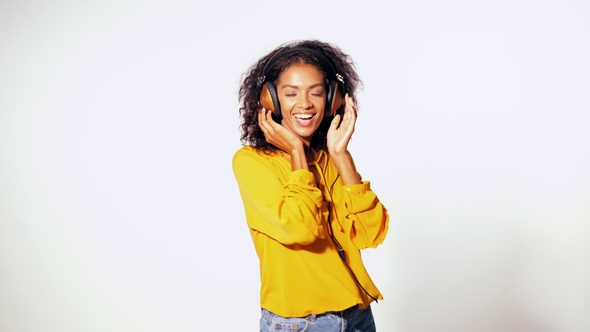 Attractive African-American Young Woman Listening To Music with Headphones