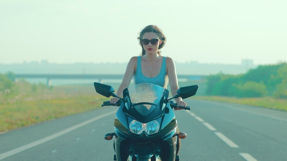 Girl Riding a Motorcycle in Sunglasses