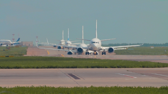 Airplanes in Queue on the Runway. Standing in Line To Take Off