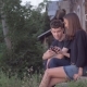 Couple Sharing Media in a Smart Phone Sitting on Stairs Beside Old Vintage House - VideoHive Item for Sale