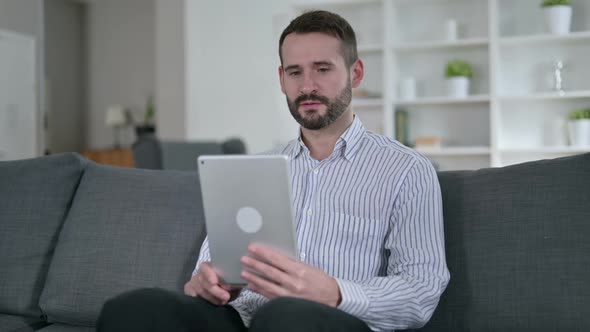 Cheerful Young Man Doing Video Chat on Tablet