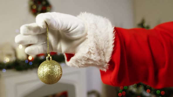 Santa claus holding christmas bauble ball