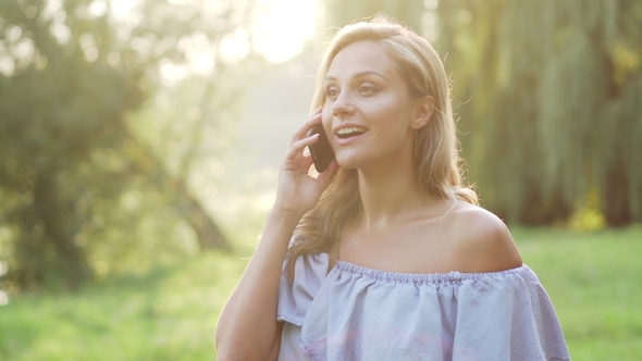 Joyful Female Speaks Briskly on Phone